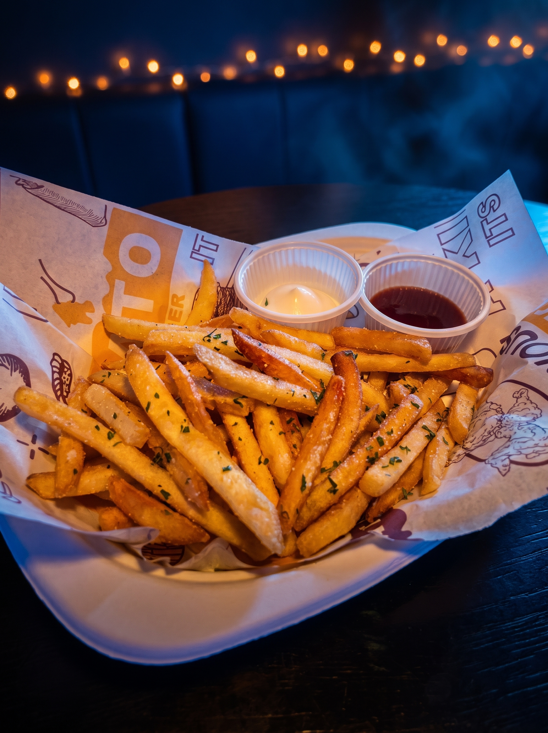 Basket of seasoned fries with dipping sauces